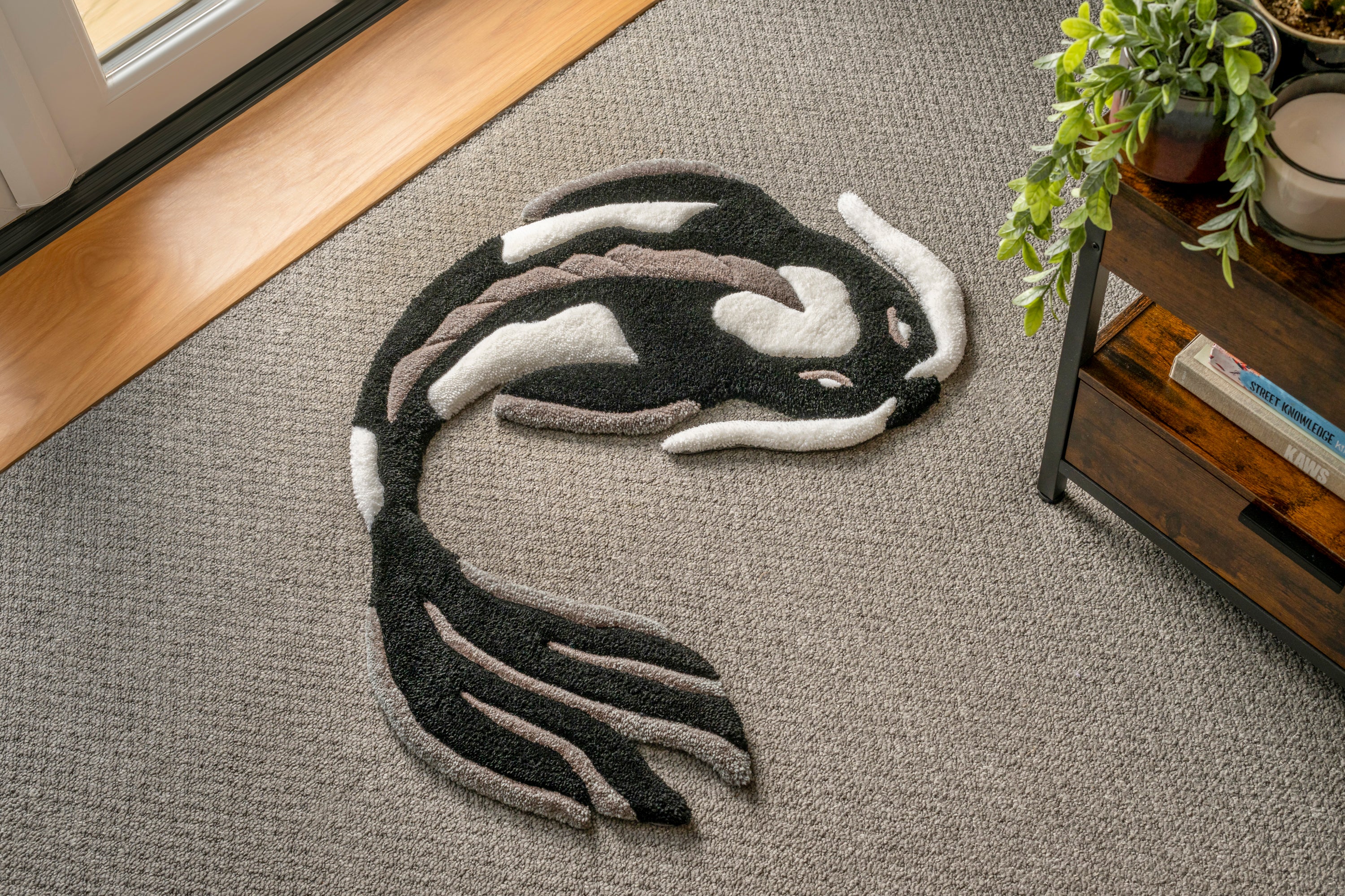 Handmade black and white koi fish rug with elegant Japanese-inspired design and soft low-pile tufted texture.