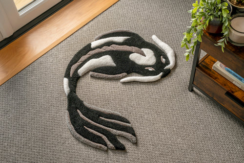 Handmade black and white koi fish rug with elegant Japanese-inspired design and soft low-pile tufted texture.