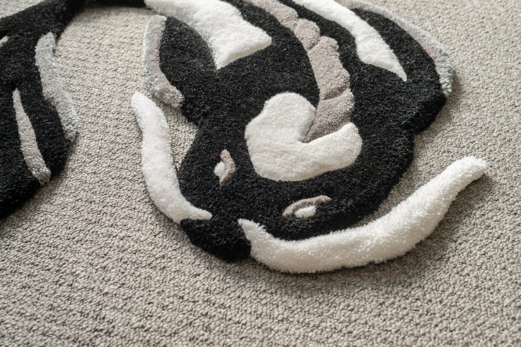 Detailed texture shot of a black and white koi fish rug crafted from soft acrylic yarn with a smooth low-pile finish.
