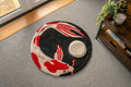 Handmade Japanese koi fish rug featuring a flowing red and cream koi beneath a raised moon on a black circular background.