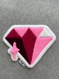 Handmade pink diamond rug featuring layered pink, burgundy and white geometric facets with a sparkling star detail.