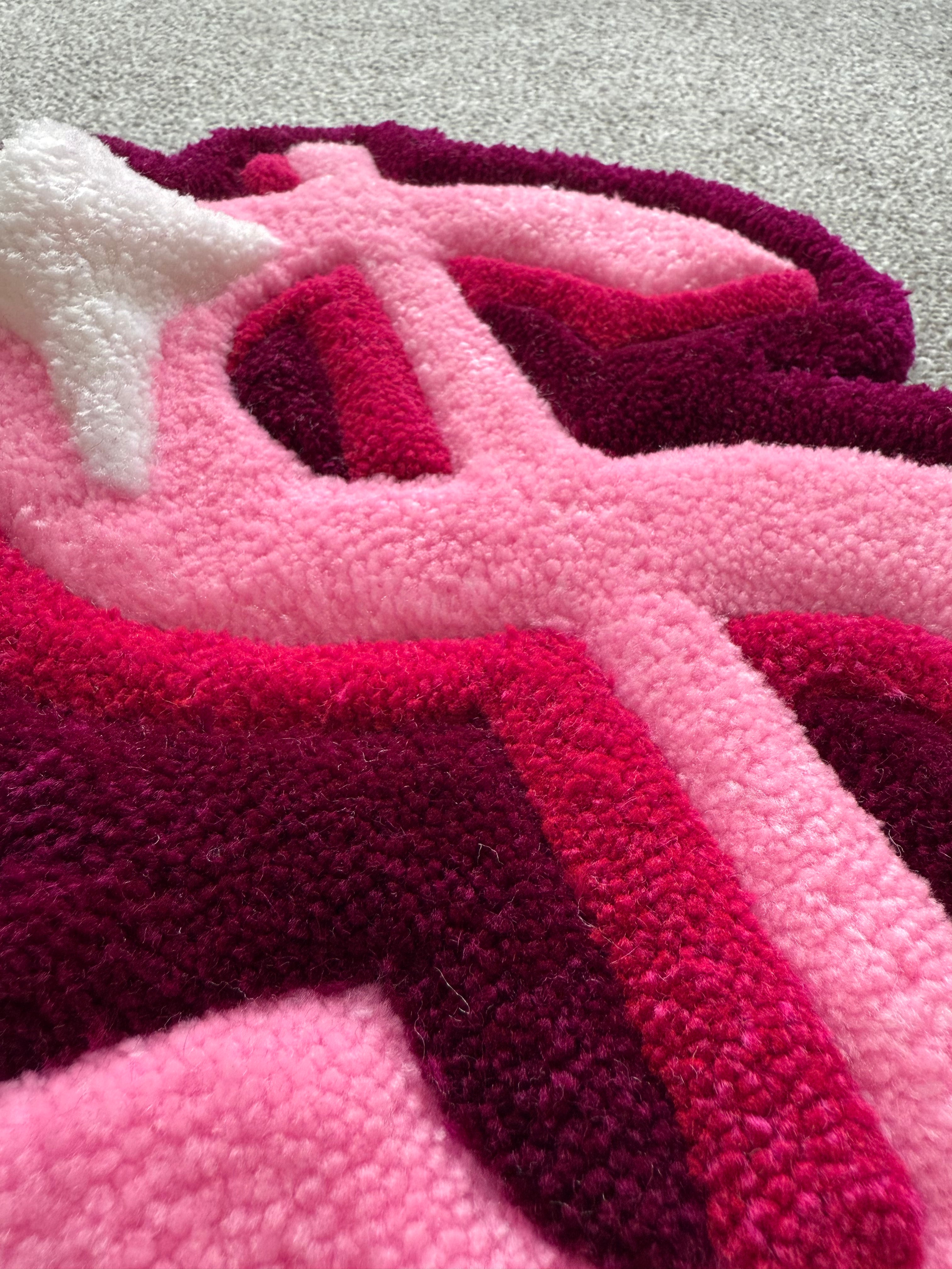Detailed close-up of the pink dollar sign rug highlighting raised tufted sections, layered colours and premium handmade craftsmanship.