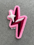 Handmade pink lightning bolt rug featuring layered pink, burgundy and white accents with a sparkling star detail.