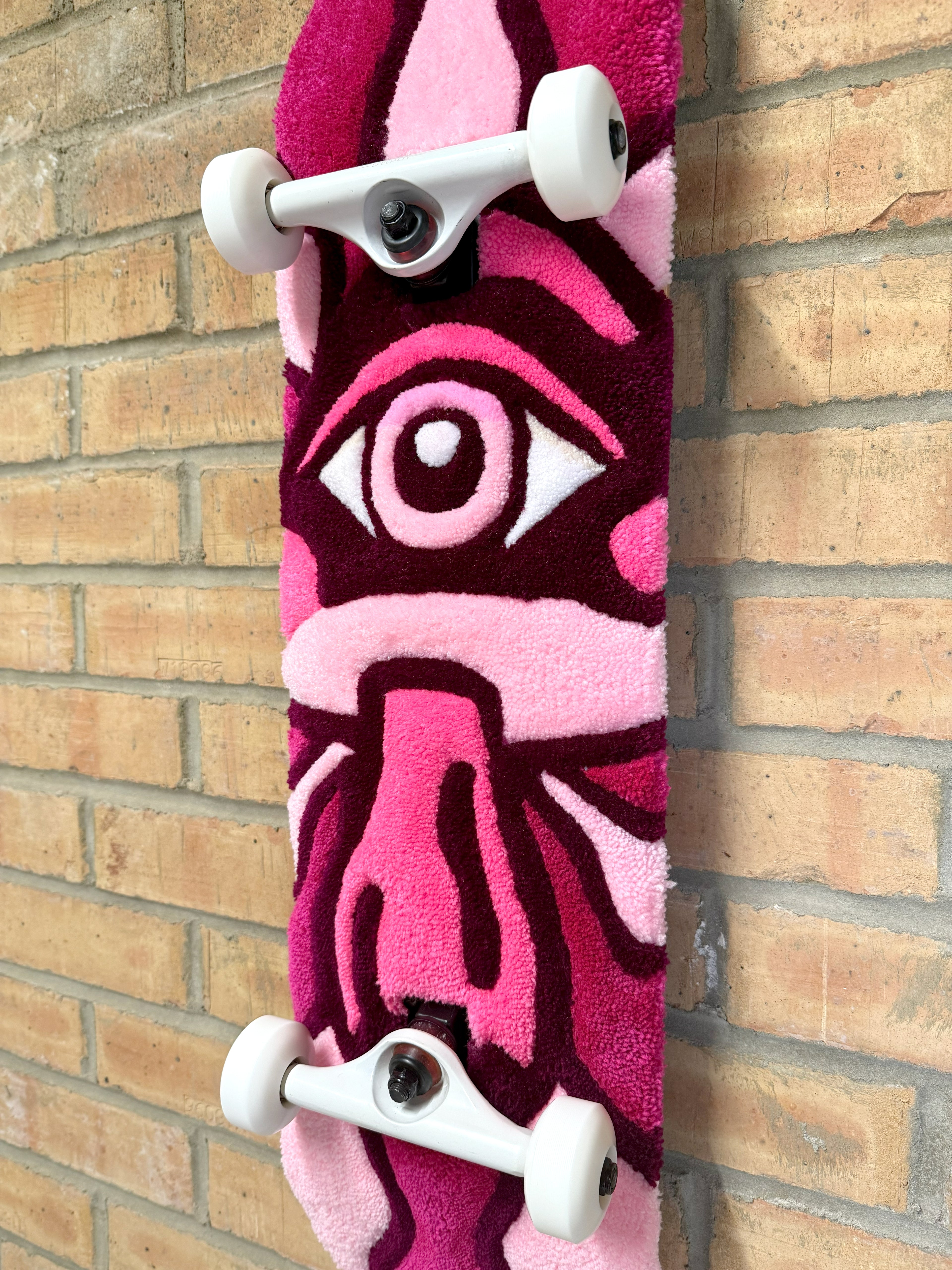 Angled view of the handmade Psychedelic Mushroom Rugboard showing the full mushroom design and skateboard deck profile.