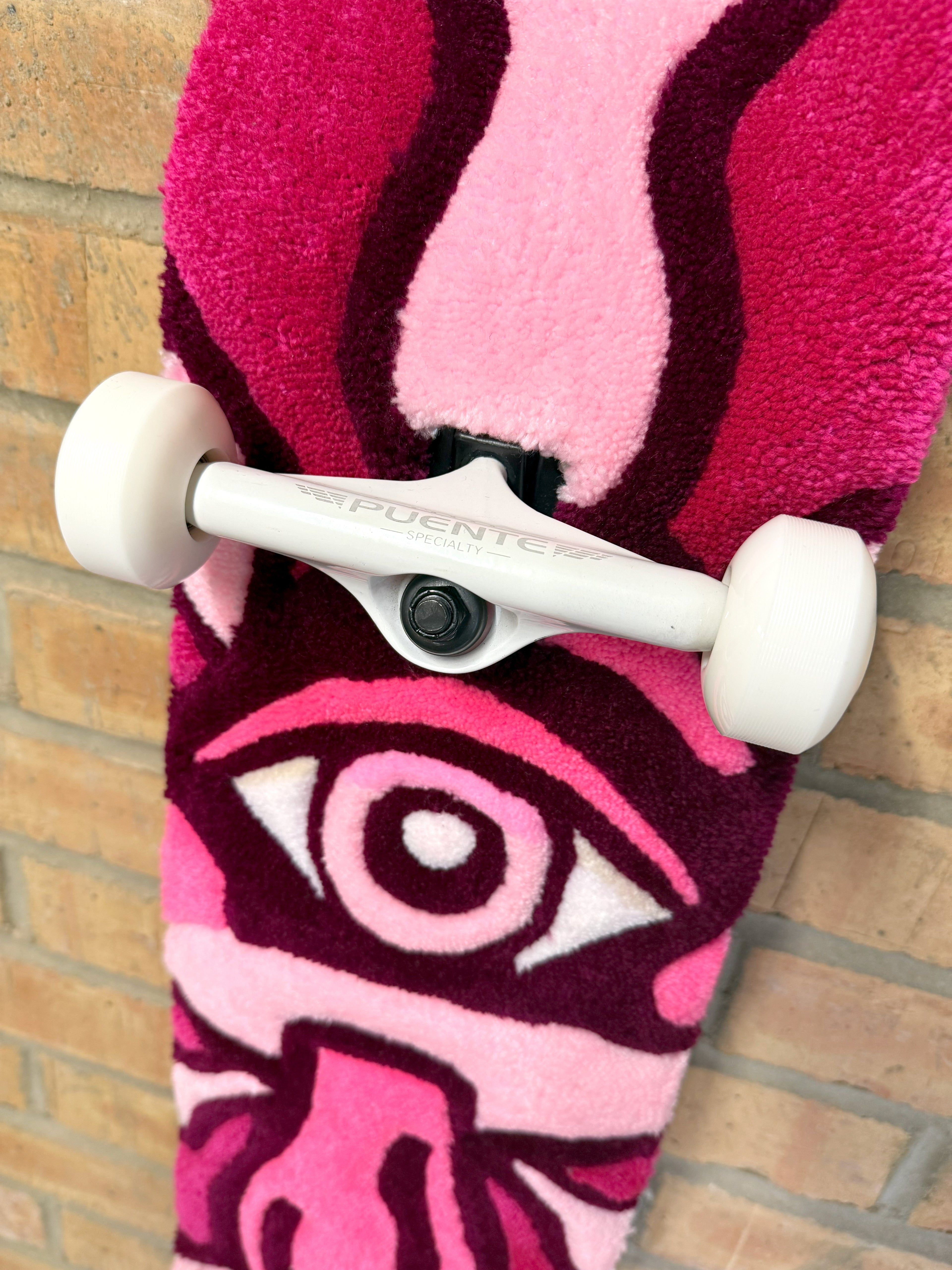 Close-up of the eye motif on the Psychedelic Mushroom Rugboard showing detailed hand-tufted textures and pink colour tones.