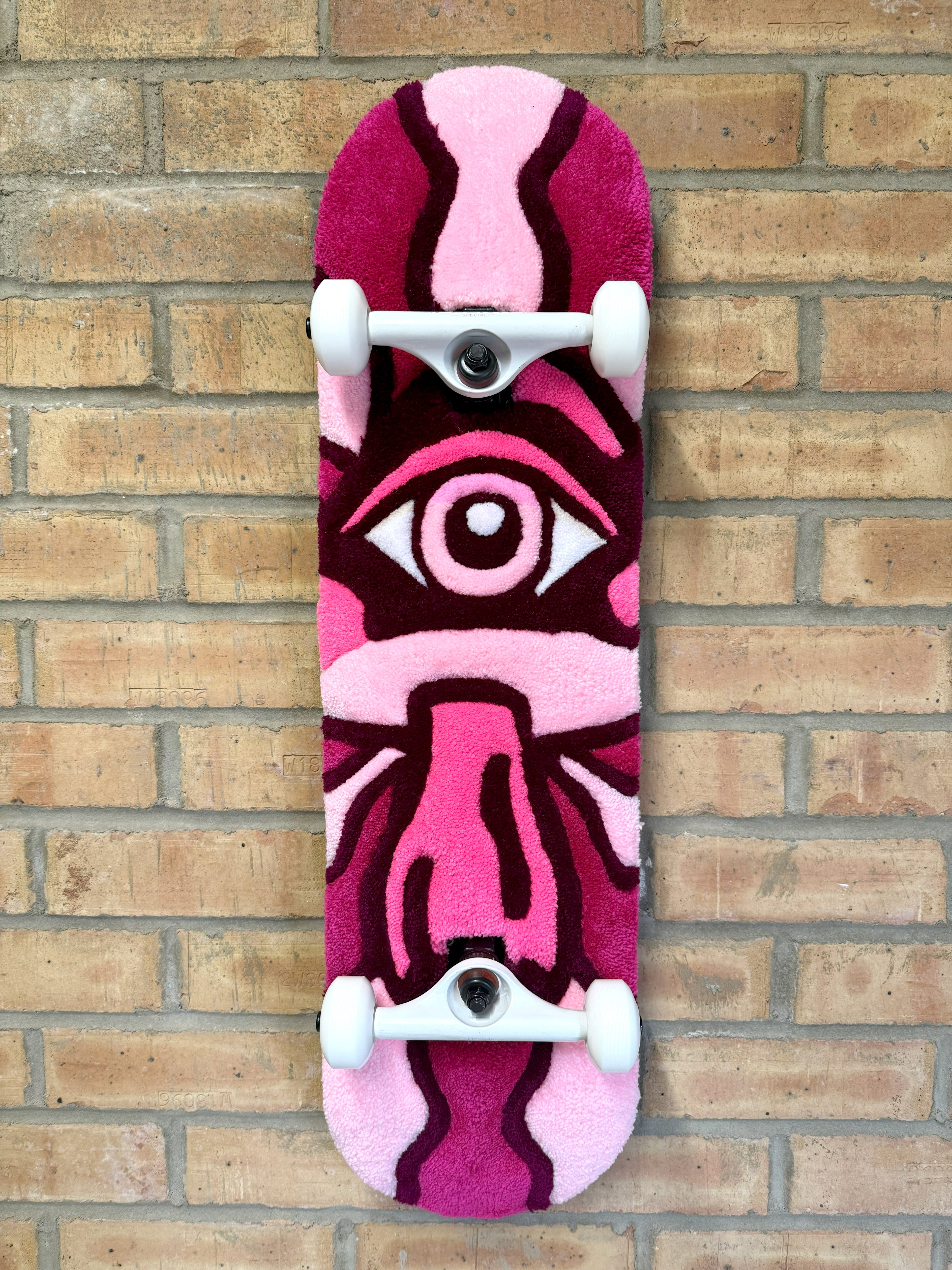 Handmade Psychedelic Mushroom Rugboard featuring a pink mushroom design with a central eye motif mounted on a skateboard deck.