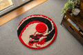 Handmade Japanese dragon rug featuring a black dragon coiled around a raised crimson sun in a circular red, black and cream design.