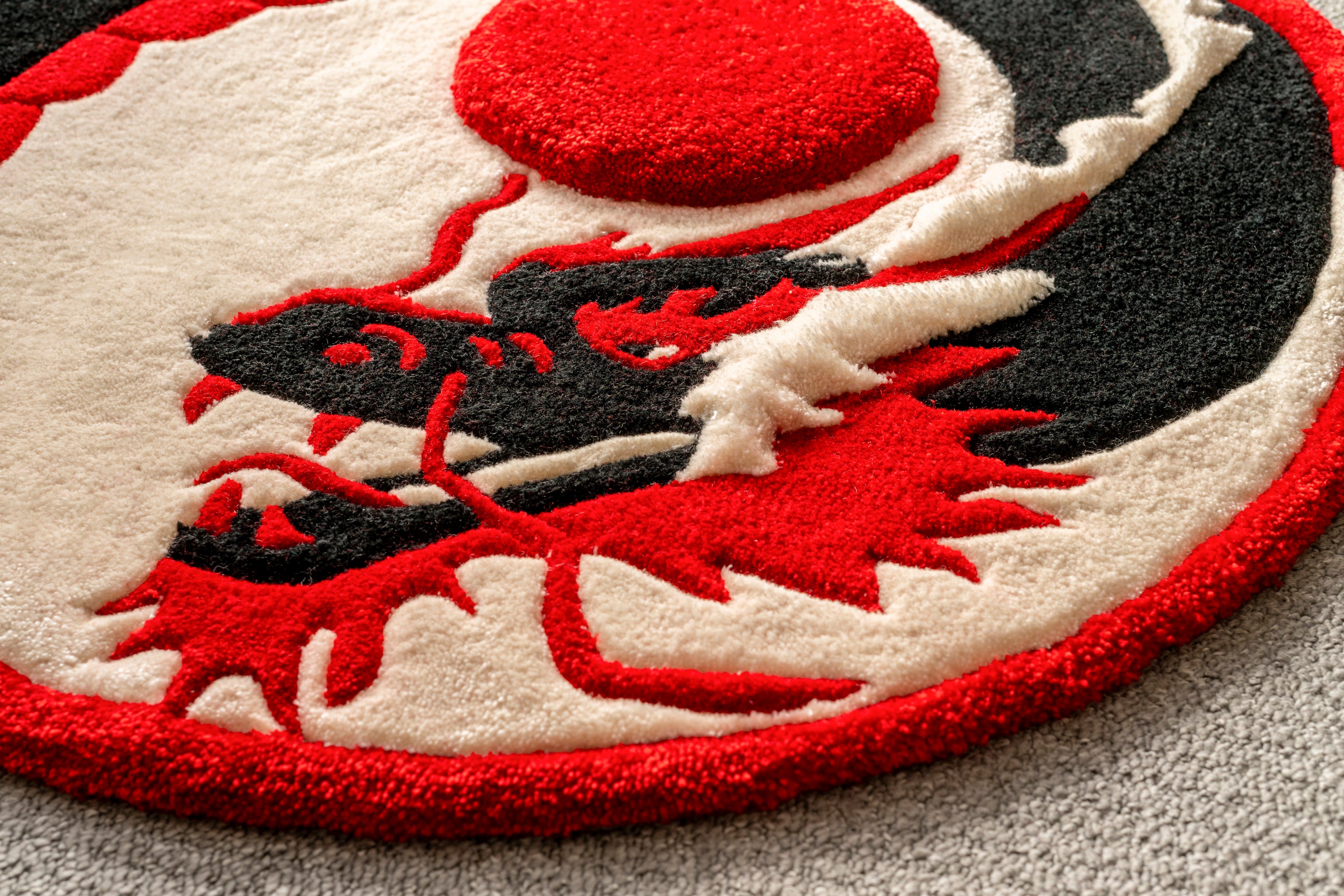 Close-up texture of the dragon design showcasing the hand tufted craftsmanship and layered pile heights.