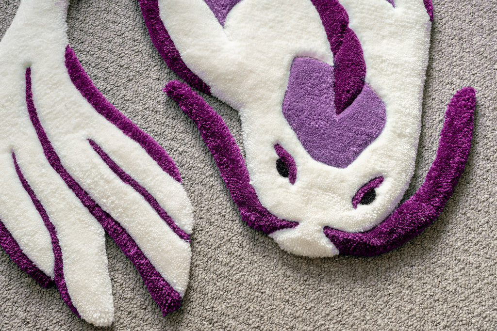 Close-up of a handmade white and purple koi fish rug showing detailed carving, sculpted edges and premium tufted finish.