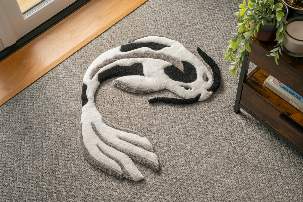 Handmade white and black koi fish rug featuring a flowing Japanese-inspired design with soft low-pile texture and neutral tones.