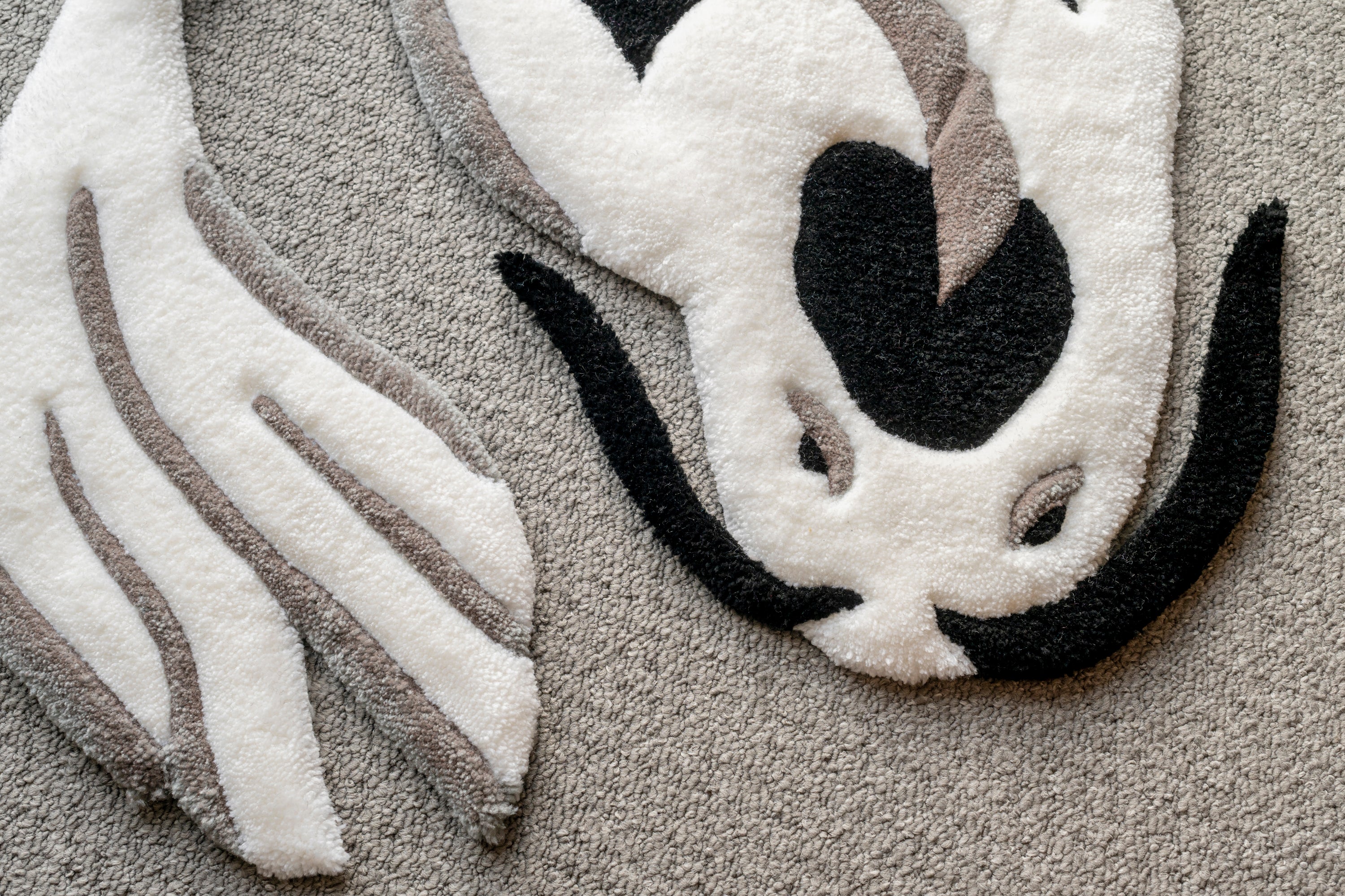 Close-up of a white and black koi fish rug showing detailed carving, premium tufting and soft acrylic yarn texture.